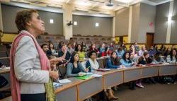 professor in lecture hall with many students seated