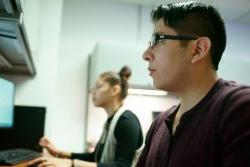 student at computer terminal in research lab